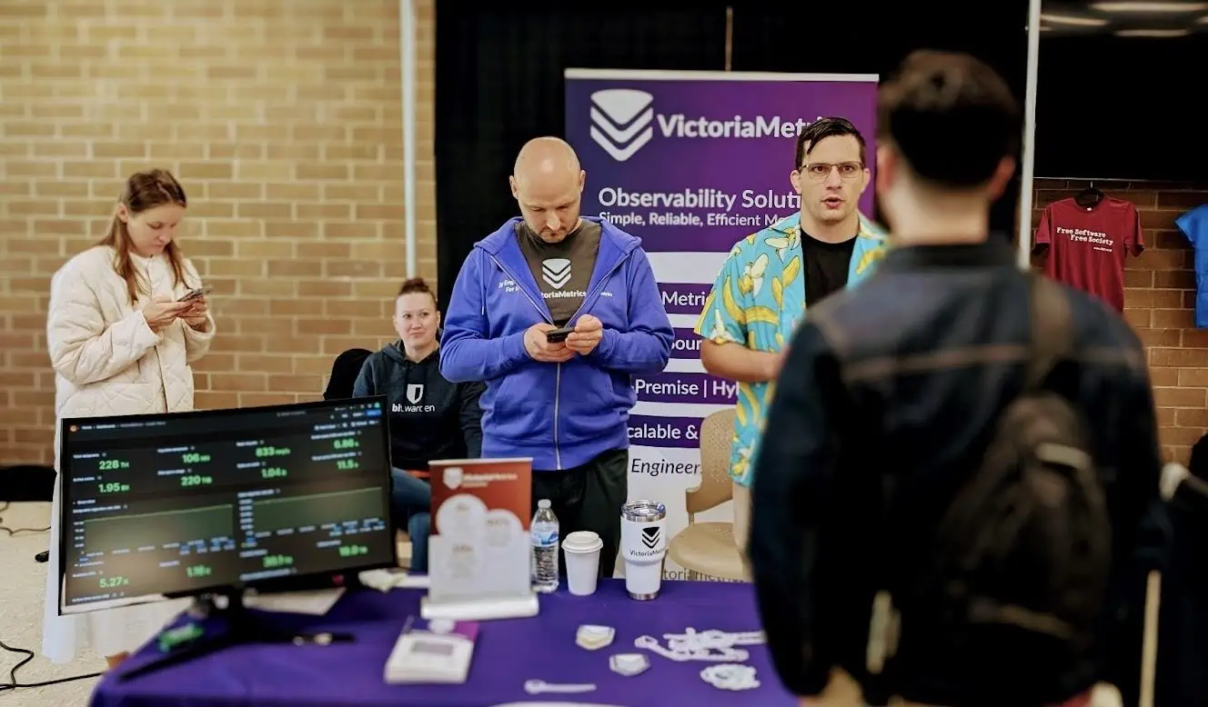 Mathias and Dima discussing observability solutions with attendees